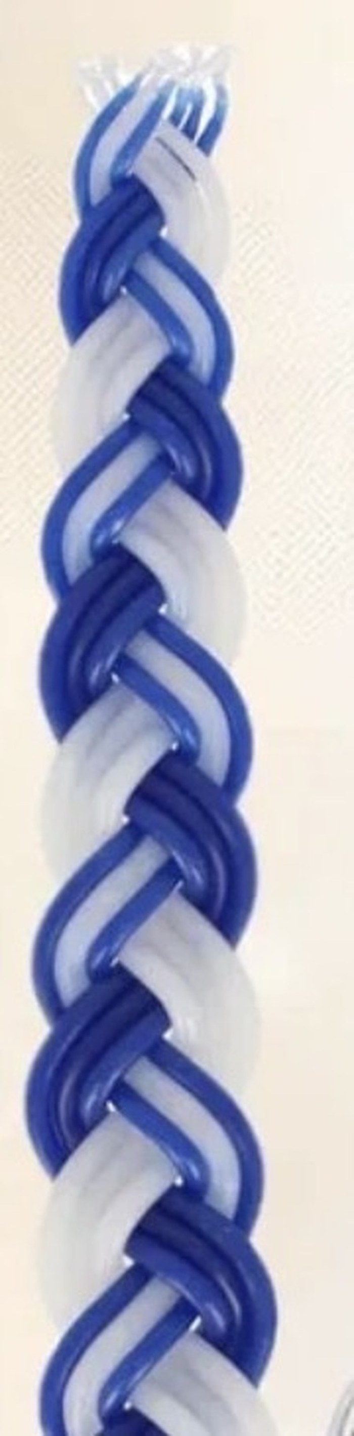 Close-up of the hand-braided blue and white blessing candle